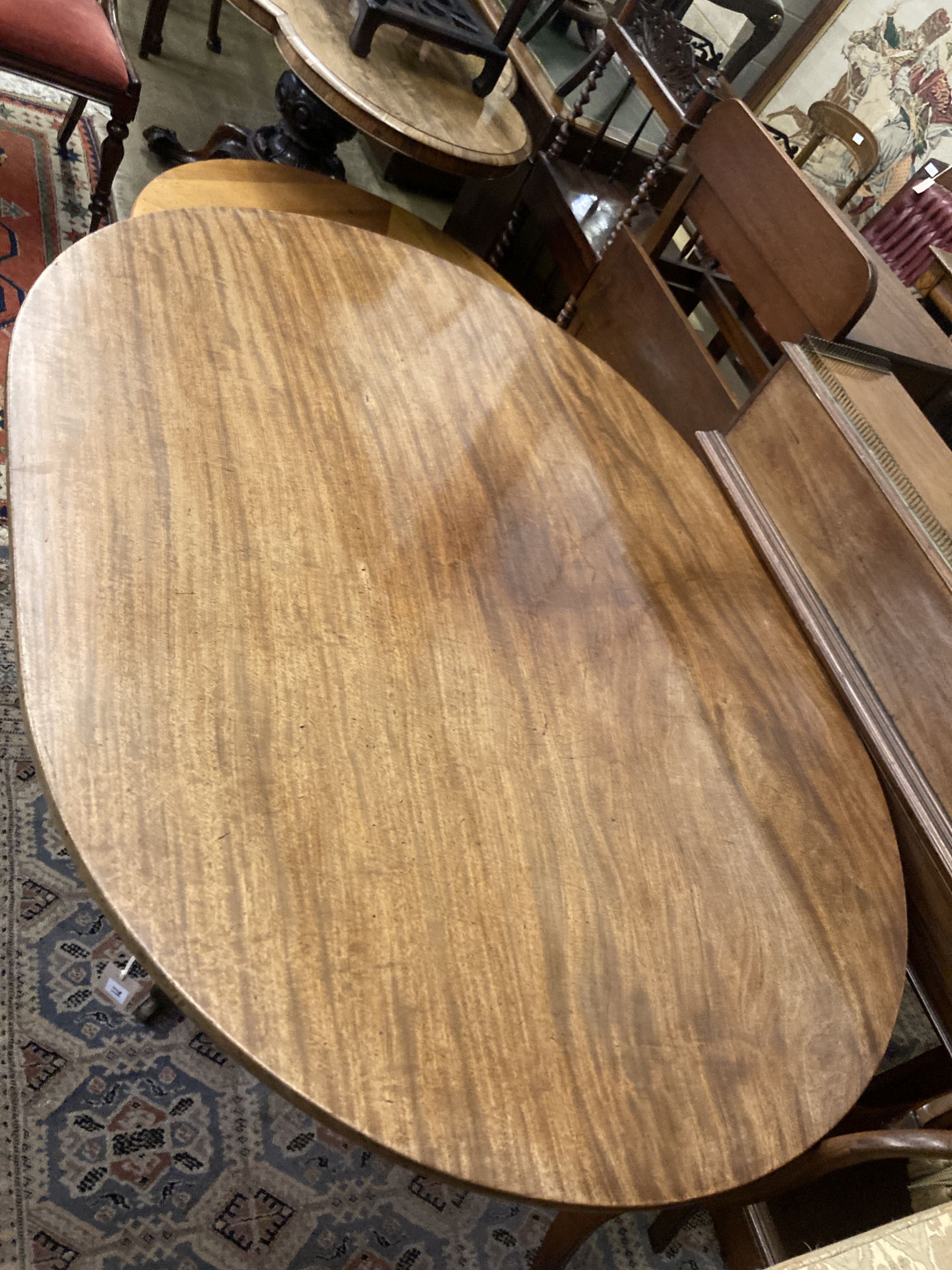 A George III oval mahogany tilt top dining table, width 158cm depth 120cm height 74cm